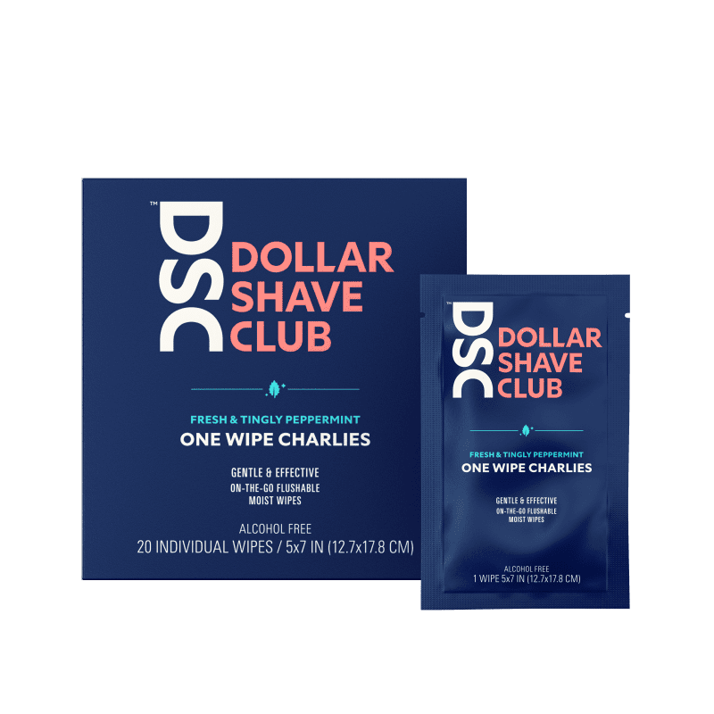 Dollar Shave Club One Wipe Charlies Butt Wipes travel size against tan backdrop.